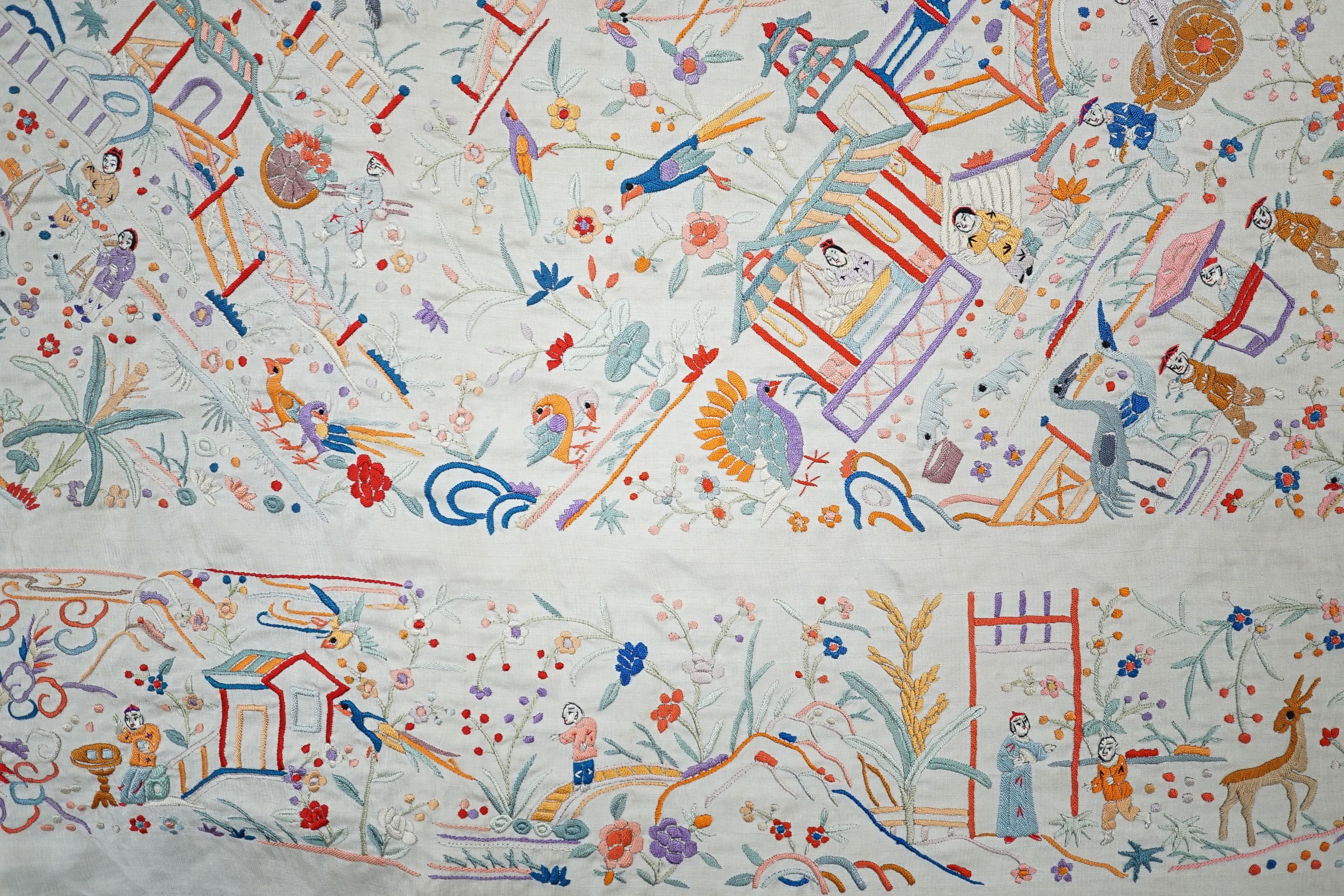 A Chinese cream silk shawl with fine multi coloured all over embroidery depicting figurative scenes and animals